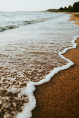 Beautiful scenery of the beach with splashing sea waves..