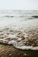 Beautiful scenery of the beach with splashing sea waves..