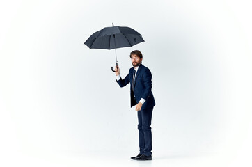 business man with umbrella in hands protection from rain bad weather Studio