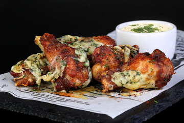 Chicken legs in teriyaki sauce on black background