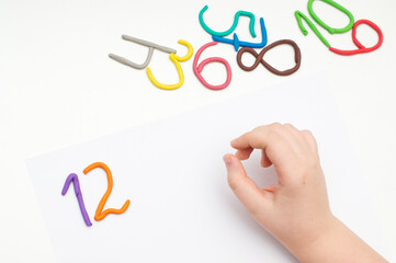 Colorful digits made from plasticine. Bright colored volumetric figures for children (isolated on white)