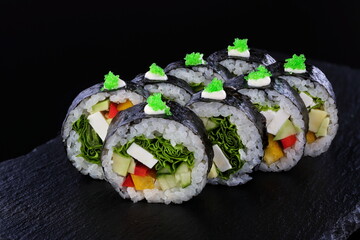 Rolls with red caviar on a black background