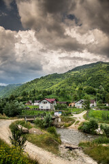 Fototapeta na wymiar Mountain landscape with a river and clouds in the Anies area, Bistrita, 2021
