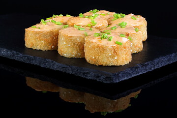 Rolls with red caviar on a black background