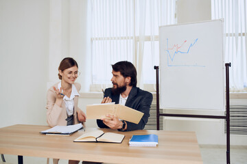 business man and woman sitting at work desk office team communication