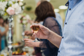 guests at the wedding cheerfully clink glasses with each other
