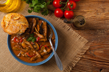 Boeuf, Stroganow, Strogonow. Classic, Russian beef stew. Served in a blue bowl. Top view. Natural background.