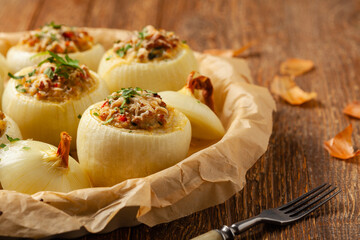 Onion baked with cheese stuffed with minced meat. Front view.  Served in parchment.