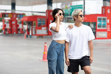 Fototapeta na wymiar portrait man and woman fashion poses with sunglasses and white t-shirt