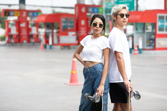 portrait man and woman skateboarder with sunglasses and fashion poses