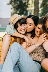 Young women, best friends outdoors, having fun, hugging and laughing.