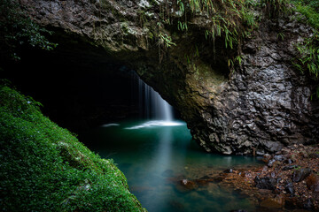 Natural Bridge with waterfall into cave