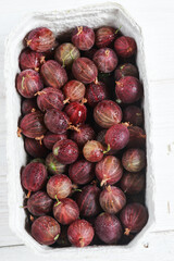 Set of organic gooseberry. Gooseberries fruits in paper baskets. Sweet and juicy berry. Top view.