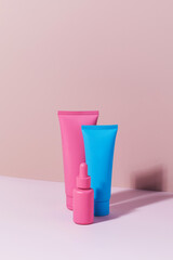 Different mockups of cosmetic bottles on a pink background. Trends in skin care.