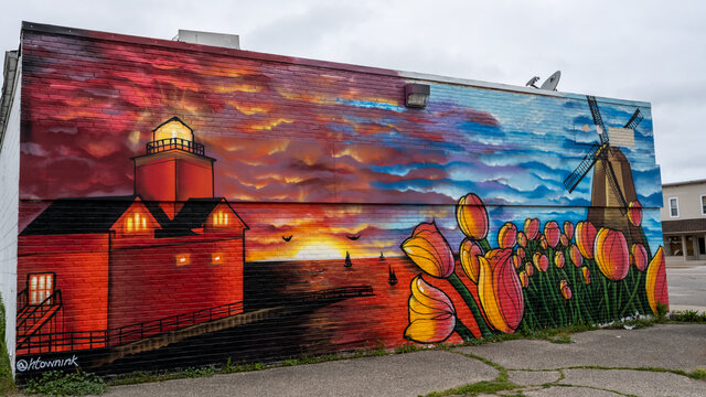 Sammy's Place mural (tulips, DeZwaan Windmill, sunset on the beach, Big Red lighthouse)., in Holland, Michigan. Artist, Chris Garcia