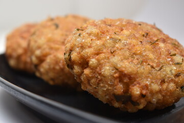 closeup shot of sabudana wada or shabudana vada resting on each other