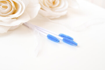 colored brushes for lash extensions in beauty salon,materials for lashmaker on white background, copy space