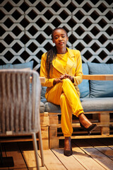 Fototapeta premium Portrait of nice-looking fashionable attractive lovely content cheerful cheery african american girl wear bright vivid shine vibrant yellow color jacket or costume.