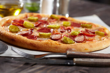 tasty pizza on the wooden background