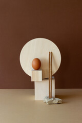 Wooden geometric shapes, stone, sticks and egg. Still life. Concept. Product design.