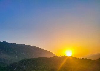 Sunset in mountains.Mountain valley during sunrise. Natural summer landscape.Colorful sunset on top of mountain.Sunrise in forested mountain