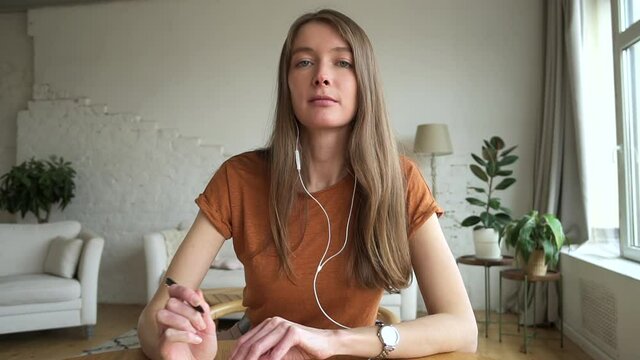 Woman write note in notebook and talk via video call, portrait webcam view. Female study on virtual