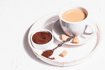 Morning cup of coffee. Ground powder, brown sugar, stand