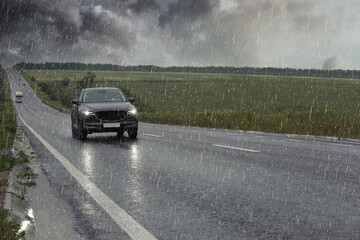 View of country road with car on rainy day © New Africa