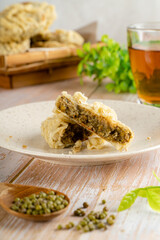 Gandasturi or kue kacang ijo. a cake from indonesia made from green beans and brown sugar, shaped round and flat, coated with flour and then fried.