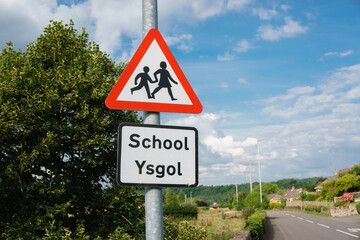 Bilingual school crossing warning sign in Welsh and English languages in rural North Wales UK - obrazy, fototapety, plakaty