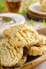 Gandasturi or kue kacang ijo. a cake from indonesia made from green beans and brown sugar, shaped round and flat, coated with flour and then fried.