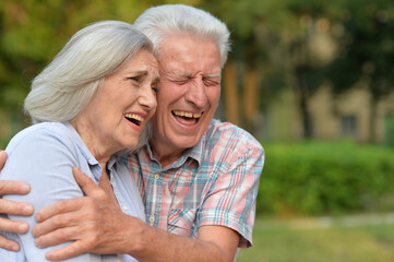 senior couple posing in the park