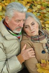 Portrait of sad senior couple in the park