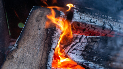 Burning firewood in the fireplace close up. - 449357992