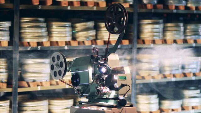 Retro technology, vintage old antique concept. Vintage video projector with smoke around it
