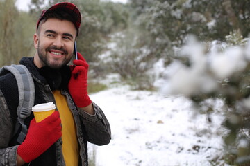 Man calling while drinking hot coffee in the cold winter