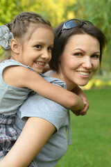 Portrait of happy mother and daughter smiling outdoors