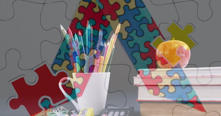 Image of puzzles falling over ribbon formed with puzzles, colour pencils and stack of books