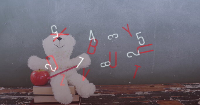 Digital composition of multiple changing numbers and alphabets against teddy bear and apple on stack