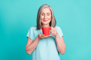 Photo of charming dreamy grandmother with closed eyes smell coffee caffeine lover isolated on turquoise color background