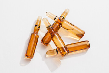 group of ampoules with serum on white background.