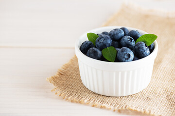 Fresh blueberries in a white bowl. Horizontal orientation, copy space.