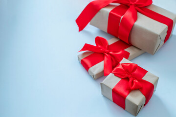 Christmas present wrapped with bright red bows on light blue background