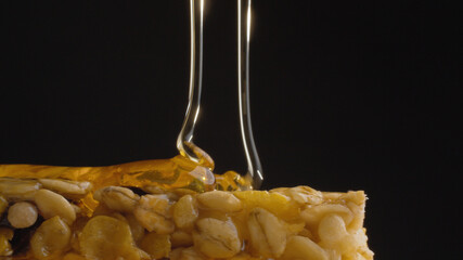 Honey pouring on a cereal bar