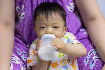 Asian Chinese baby boy drinking milk