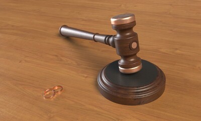 Wedding rings and wooden gavel of judges on the table close up. 3d rendering