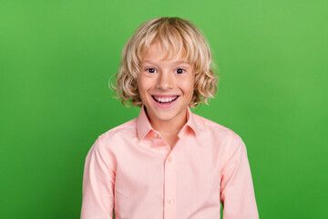 Photo of young happy amazed positive boy smile good mood cheerful isolated on green color background