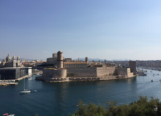Fototapeta na wymiar Panoramic view of Fort Saint-Jean with Marseille Cathedral and Mucem museum on the left and the entrance to the Old Port to the right, seen from the Pharo Palace in Marseille, France.