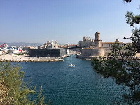 Panoramic view of Fort Saint-Jean on the right and Marseille Cathedral and Mucem museum on the left, seen from the Pharo Palace in Marseille, France.
