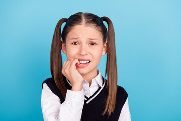 Photo of sad small brunet girl bite fingers wear white shirt vest isolated on blue color background